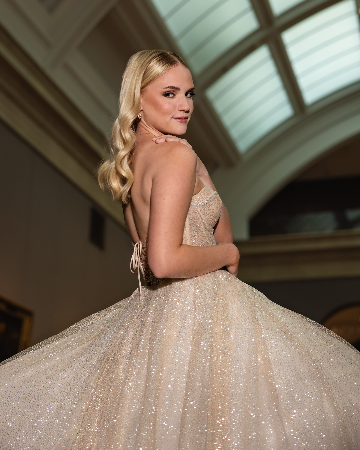 High School Senior Girl posing in a champagne colored Polardi gown at the Cleveland Museum of Art during a senior photo session